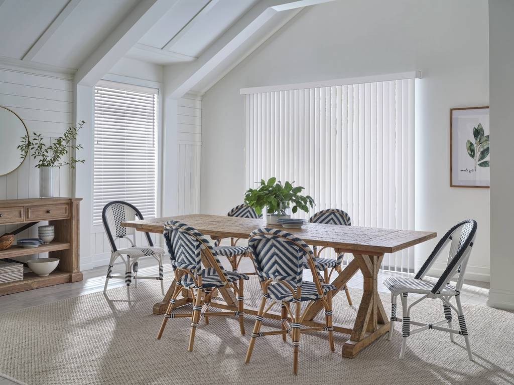 Bright and open kitchen with large windows decorated with Hunter Douglas Vertical Blinds near Springfield, IL