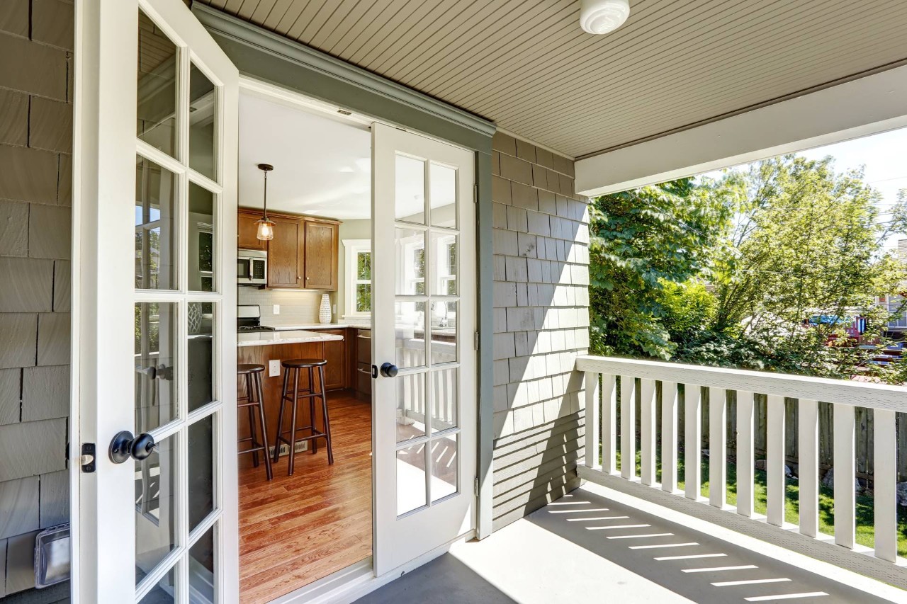White exterior French Doors, without cellular shades, leading from a kitchen to a walkout deck at House to A Home Interiors near Springfield, IL