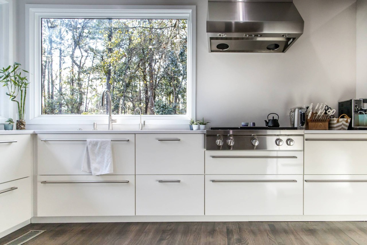 A picture window without vertical blinds above the kitchen sink in a clean, modern space at House To A Home Interiors near Springfield, Illinois