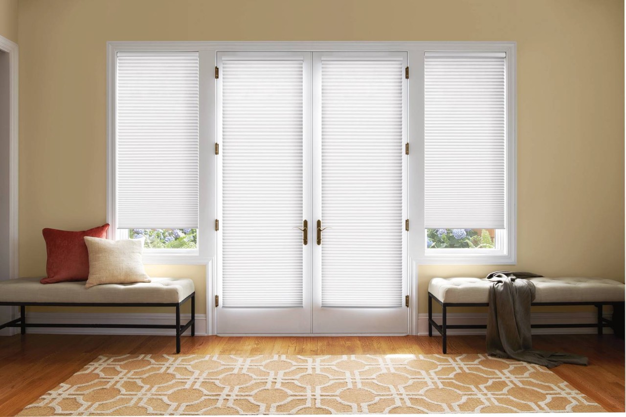 Double doors in a home with sidelights decorated with Hunter Douglas Duette® Cellular Shades at House to a Home Interiors near Springfield, IL